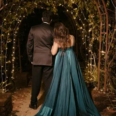 An enchanting night shot from a pre-wedding session. The bride's gown is complemented by makeup with blue shimmers on the eyes and elegant beach waves in her hair.