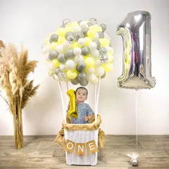 A creative "hot air balloon" themed photoshoot for a first birthday. I can help arrange unique and memorable setups for milestone pictures.