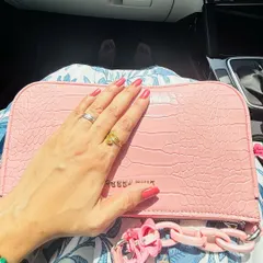 Details matter in desi styling. The pink textured clutch adds a pop of color and modern flair to the traditional floral print of the kurta set, showing how to mix classic and contemporary accessories.