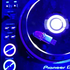 The custom USB drive in its natural habitat, plugged into a Pioneer DJ deck. It’s a small detail, but having custom gear that reflects my brand is important, whether I'm in the studio or playing a gig.