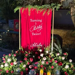 My signage is often the first thing guests see, setting the tone for an event. I loved designing this minimal yet dramatic acrylic sign for a 60th birthday, where my calligraphy popped against the rich red backdrop, disco balls, and lush florals.