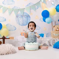 With a sky-themed backdrop and a sweet cake to dig into, this little one is on cloud nine for his first birthday celebration.
