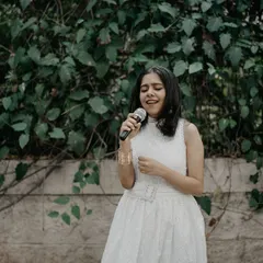 A candid moment of singing at an outdoor event. I am comfortable performing in various settings, from intimate indoor spaces to larger open-air venues.