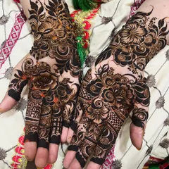A perfect example of my intricate floral work with fresh, natural henna paste. The contrast is sharp and the lines are clean, showing the artistry before the beautiful stain even develops. This design features bold flowers with delicate fillings.