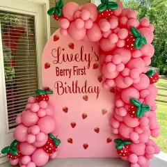 A sweet "Berry First Birthday" with a strawberry theme. I used a pink arched backdrop and a custom balloon garland with cute strawberry balloon accents.