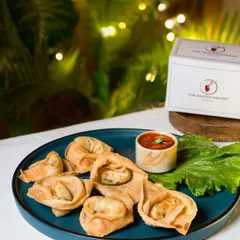 Our crispy fried wontons are filled with a delicious vegetable mix and fried to a perfect golden brown. Served on a platter with a side of spicy dipping sauce, they are an irresistible treat.