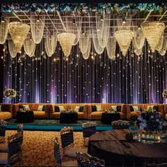 For a more intimate and interactive session, we can design a lounge style seating arrangement on the main floor. This setup features elegant draping, chandeliers, and comfortable sofas, perfect for a fireside chat or a VIP networking event.