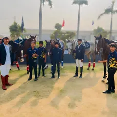 The Uma Equestrian Academy team, composed of riders of different ages, gathers for a group photo, showcasing our inclusive and goal oriented community.