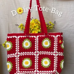 A full view of our vibrant red daisy tote bag. The combination of bold red and cheerful daisies makes this a standout piece for any season.