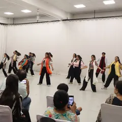 Another angle of our student showcase, capturing the synchronized movement and colorful costumes of the performance. Every student gets their moment to be a star.