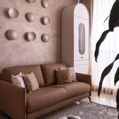 This bedroom is an exercise in soft luxury. I used a palette of grounded neutrals and sculpted textures, like the backlit concave discs on the wall, to create a space that feels both artistic and deeply calming.