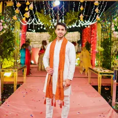 A perfect look for a daytime wedding event. This client is wearing a simple white kurta with an orange stole, and my grooming service provided a fresh, natural look to match the elegant and traditional vibe.
