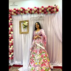 A happy client in a beautiful white floral lehenga. The bright, colorful embroidery makes it a perfect choice for a Mehendi or a spring wedding.