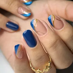Here, I combined a classic French with modern art. This set on natural nails features a deep ink blue, a glitter cat eye effect, and delicate gold lines for a sophisticated and unique design.