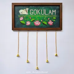 I love creating custom nameplates that reflect a family's personality. This "Gokulam" nameplate features a Pichwai-style cow and lotus details on a rich green background, complete with little hanging bells for a charming touch.