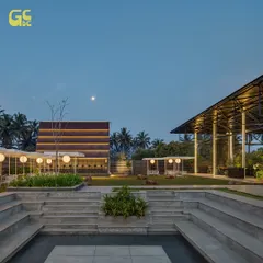 An evening view of the entire property, showing the amphitheater, lawns, and architectural elements under the moonlit sky. It's a tranquil world of its own.