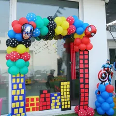 An action-packed entrance for a superhero party with balloon columns designed to look like city buildings.