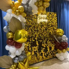 Our gold shimmer wall is all about luxury and celebration. For this birthday event, we created an asymmetrical organic balloon arch with gold, white, grey, and maroon balloons, adding dried palm leaves for a trendy, textured look.