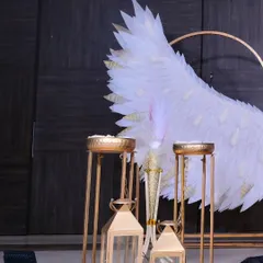 A close-up of the decorative details, including golden lanterns and candle stands that add a warm and elegant glow to the baptism setup.