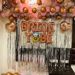 A chic and modern photo booth I designed for a bride-to-be party. This setup uses a popular color scheme of rose gold, pink, and grey balloons, with a shimmering silver fringe backdrop. The large 'BRIDE TO BE' foil balloons, complete with a diamond ring detail, make it a perfect spot for pictures.
