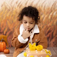 The moment of sweet anticipation right before the smash. This little one is mesmerized by his beautiful birthday cake in our autumn-themed studio setup.