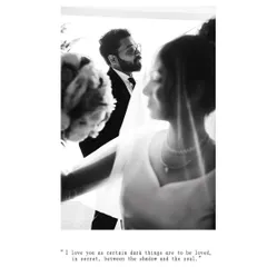 An artistic black and white photo capturing a soft, intimate moment between the bride and groom.