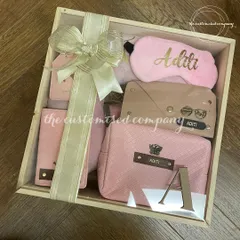 This is the ultimate travel-themed Rakhi hamper for a sister who loves to explore. The personalized wooden crate contains a matching passport cover, luggage tag, sunglass case, pouch, and eye mask, all in a lovely shade of pink.