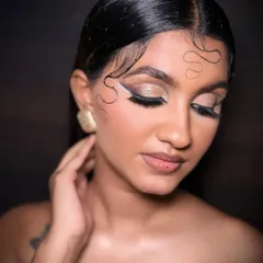 This pose highlights the sculpted cheekbones and the seamless blend of the airbrush foundation, achieving a flawless finish that's essential for editorial photography.