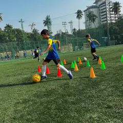 Football is the language we all speak. Here, our players are deep in a cone drill, mastering their dribbling skills.