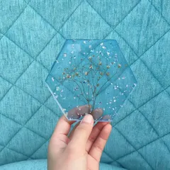 Another shot of the Gypsophila coaster against a different background. The transparency of the resin makes it look like the flower is floating in water.