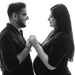 A high-contrast silhouette of a couple sharing a smile. This black and white style emphasizes their connection and the joy of the moment.