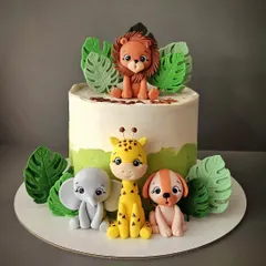 I love making jungle theme cakes! This one features a whole crew of hand-sculpted fondant animals, including a lion, elephant, giraffe, and dog, surrounded by tropical leaves.