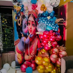 A closer look at the vibrant balloon arch and backdrop for a Krishna themed naming ceremony. We use a mix of metallic, chrome, and confetti balloons in multiple colors to create a rich and textured photo corner.