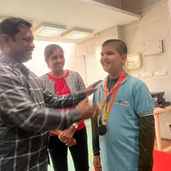 A proud moment as I award a medal to a young winner at a state-level competition. Seeing our students succeed is the greatest reward.