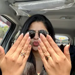 A happy client showing off her fresh, natural-looking manicure with a subtle French tip. It's a versatile look that's perfect for everyday confidence.