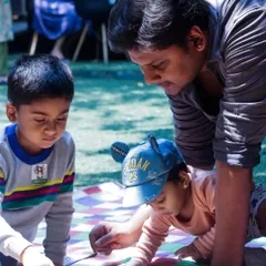 A father helps his kids with a craft project during our special Father's Day playdate. Our events are all about creating opportunities for families to spend quality time together.