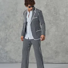 A full-length view of our bold black and white striped suit. Paired with a textured white shirt, this look is the epitome of modern, confident style.