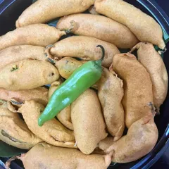 Crispy Mirchi Vada, a spicy and flavorful snack perfect for a weekend indulgence. This was part of a larger curated meal platter, designed to bring a variety of tastes and textures to your gathering.