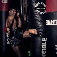 Fight for your dreams. This shot captures the intensity of a heavy bag workout, where we drill powerful kicks to build technique and endurance. This is where you learn to push past your limits.