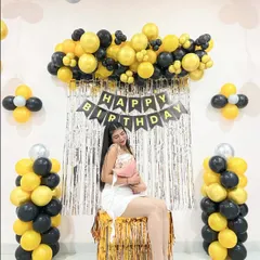 A full view of the simple birthday backdrop with balloon pillars on the sides.