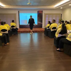 A wide view of my training setup for a corporate workshop. I ensure the environment is comfortable and conducive to learning, allowing for both group discussion and individual reflection on topics like business etiquette and professional grooming.