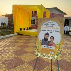 For this Haldi and Sangeet ceremony, I created a simple yellow draped stage and a personalized welcome sign for the couple, adding a lovely custom touch to the event entrance.