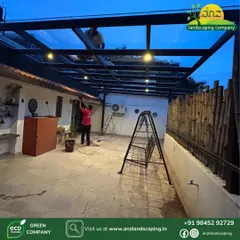 Our team is seen here giving the final touches to a clear glass pergola installation. We handle all fabrication and electrical work to ensure a seamless and professional execution for every project.