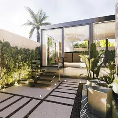 This daytime view shows a glass-encased patio lounge set in a lush garden. The design includes a paved walkway with ground-level lighting, leading up to the elevated structure.