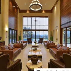 The double-height living room of the Khandala weekend home. We designed this expansive space with large windows to frame the stunning valley views, while the use of leather and wood brings warmth and richness to the interior.