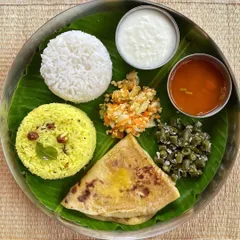 A classic Ugadi festival meal. Festivals are for enjoying guilt-free with family. One high-calorie meal like this plate with obbattu, lemon rice, and other traditional dishes will not derail your progress.