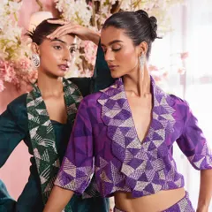A close-up shot highlighting the interaction between two models and their complementary makeup. The look features a subtle shimmer on the eyes and a soft pink lip, perfect for festive occasions.