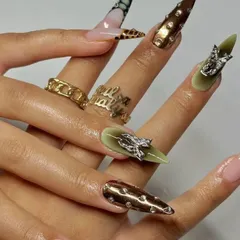 An edgy and intricate design with metallic studs, 3D chrome elements, and animal print accents on long stiletto nails.