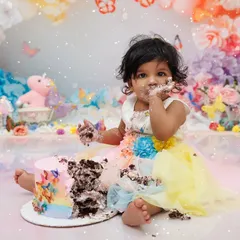 A beautiful mess! This little girl is enjoying every moment of her colorful cake smash session.