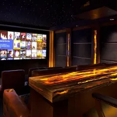 This entertainment space combines a high-performance home cinema with a custom-built, backlit onyx bar. It’s a perfect example of how we integrate leisure and luxury, creating a versatile room for both watching films and socializing.